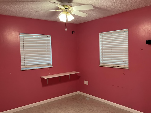 unfurnished room featuring ceiling fan and a textured ceiling