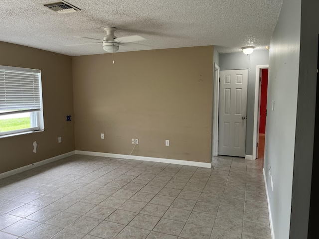 spare room with ceiling fan and a textured ceiling