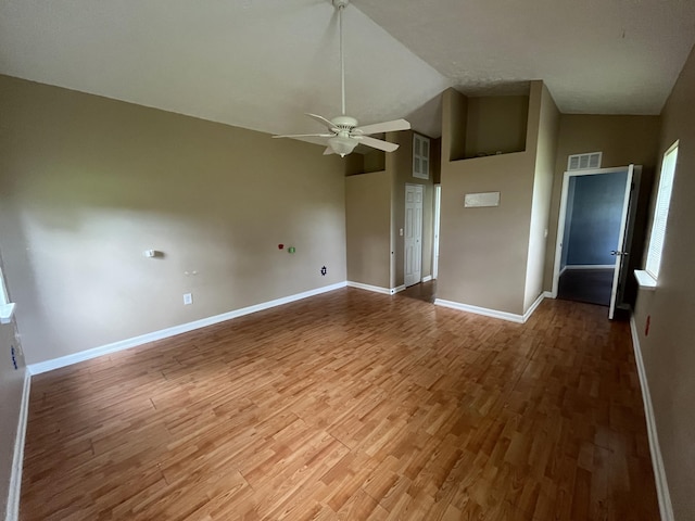 unfurnished bedroom with ceiling fan, high vaulted ceiling, and hardwood / wood-style flooring