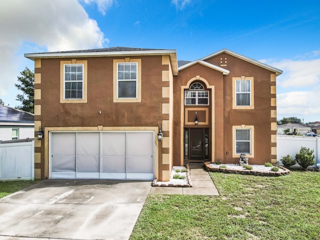 view of front of property with a front yard and a garage