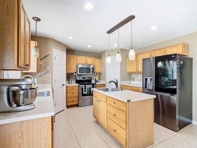 kitchen with pendant lighting, light tile patterned floors, sink, a center island with sink, and stainless steel appliances