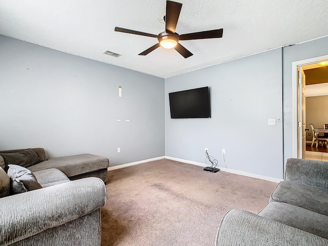 living room featuring ceiling fan, a textured ceiling, and carpet flooring