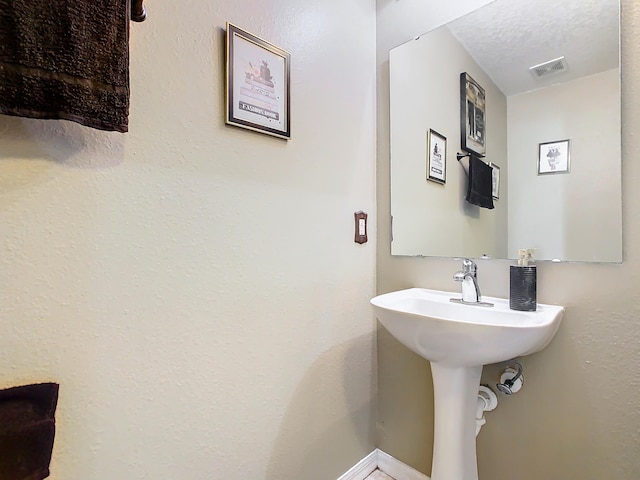 bathroom with a textured ceiling