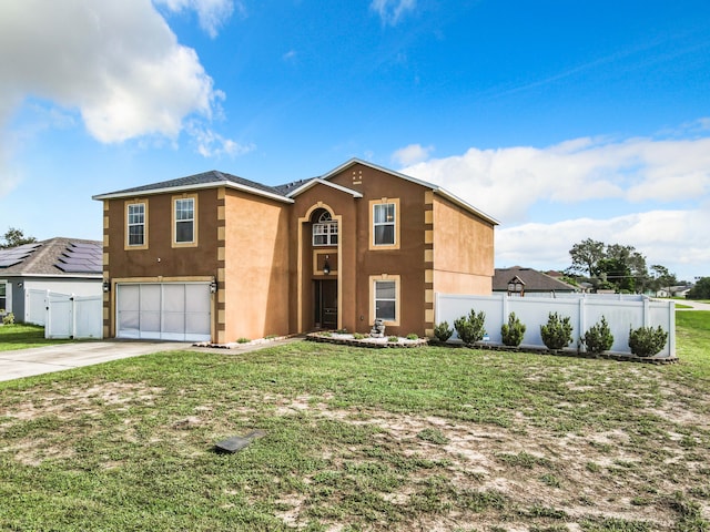 view of front of home with a front lawn and a garage