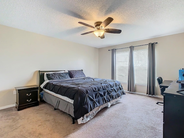 carpeted bedroom featuring a textured ceiling and ceiling fan