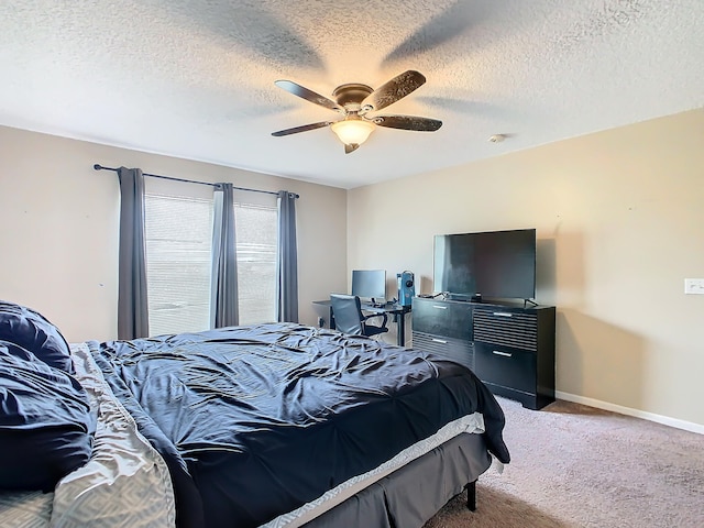 bedroom with carpet floors, a textured ceiling, and ceiling fan