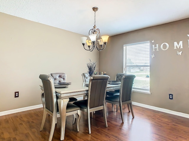 dining room featuring an inviting chandelier and dark hardwood / wood-style flooring