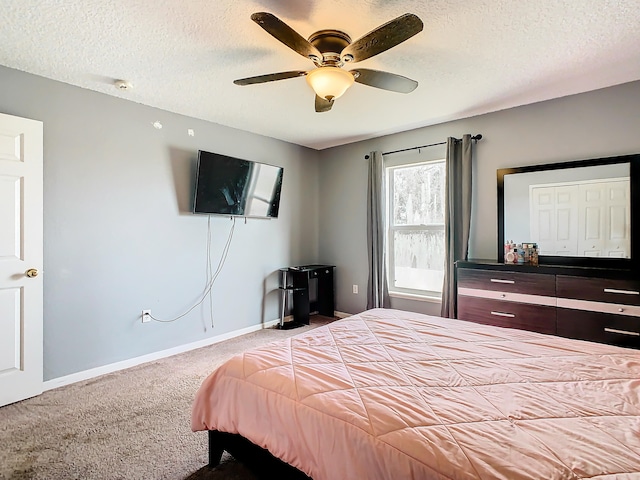 carpeted bedroom featuring a textured ceiling, ceiling fan, and a closet