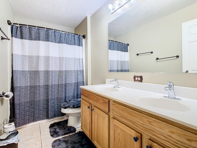 bathroom featuring a textured ceiling, a shower with curtain, tile patterned floors, vanity, and toilet