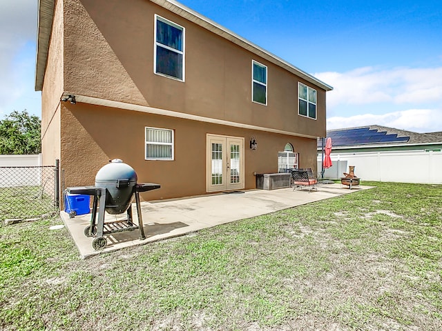 back of property featuring a lawn and a patio