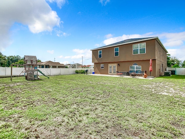 exterior space featuring a lawn, a patio, central AC unit, and a playground