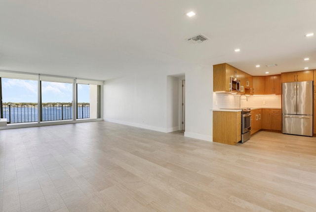 interior space featuring light wood-type flooring and expansive windows