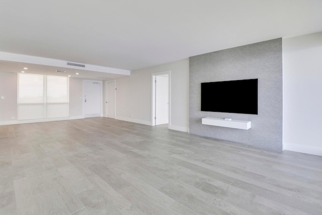 unfurnished living room featuring light hardwood / wood-style flooring