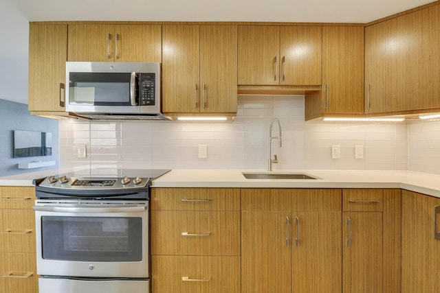 kitchen with stainless steel appliances, tasteful backsplash, and sink