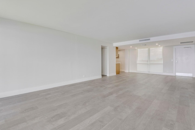 unfurnished room featuring light hardwood / wood-style floors