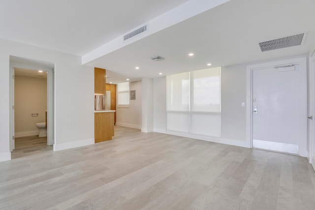 unfurnished living room with light wood-type flooring