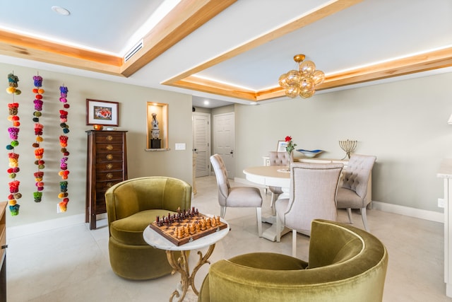 dining room with an inviting chandelier and a tray ceiling