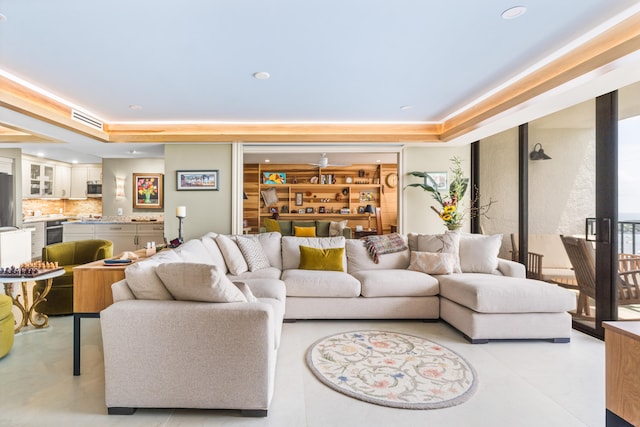 living room featuring a raised ceiling