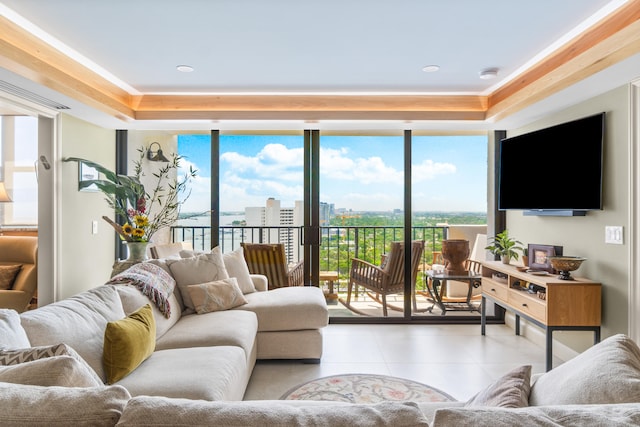 tiled living room featuring a wealth of natural light and a tray ceiling