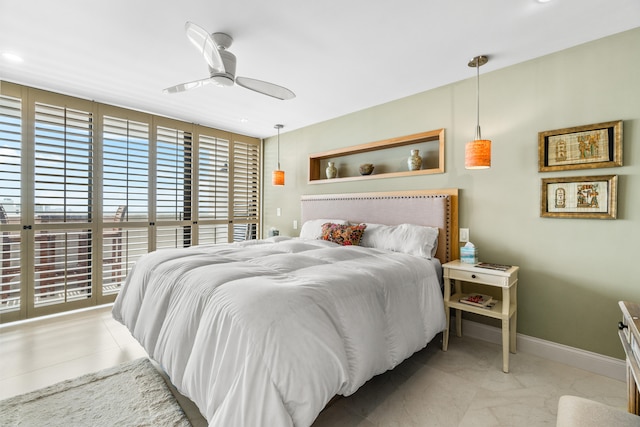 bedroom with multiple windows and ceiling fan