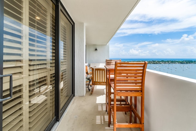 balcony featuring a water view