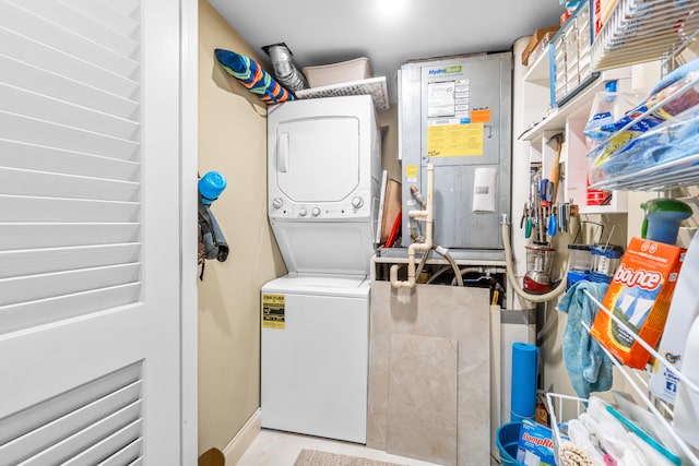 clothes washing area featuring stacked washer / dryer