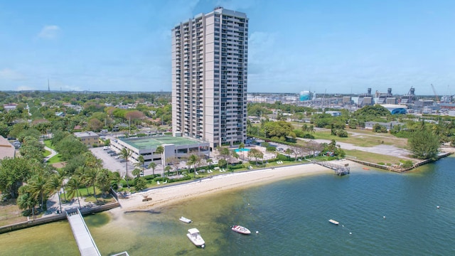 drone / aerial view featuring a water view and a beach view