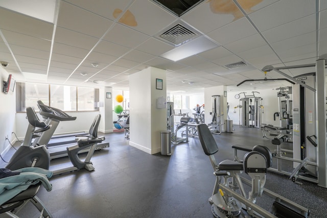 gym featuring a wealth of natural light and a drop ceiling