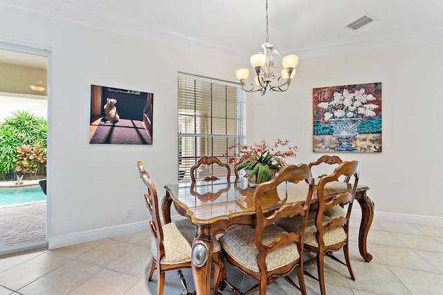 dining room with crown molding, light tile patterned floors, and a chandelier