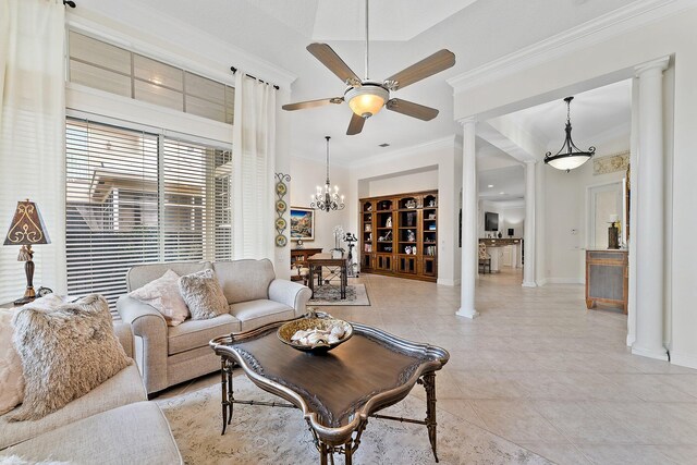 living room with light tile patterned floors, ceiling fan with notable chandelier, crown molding, and ornate columns