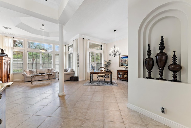 interior space featuring ornamental molding, ceiling fan with notable chandelier, and ornate columns