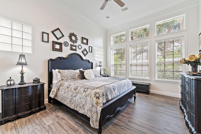 bedroom with ceiling fan, ornamental molding, a textured ceiling, and dark hardwood / wood-style flooring