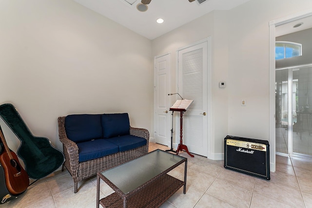 sitting room featuring light tile patterned floors and ceiling fan