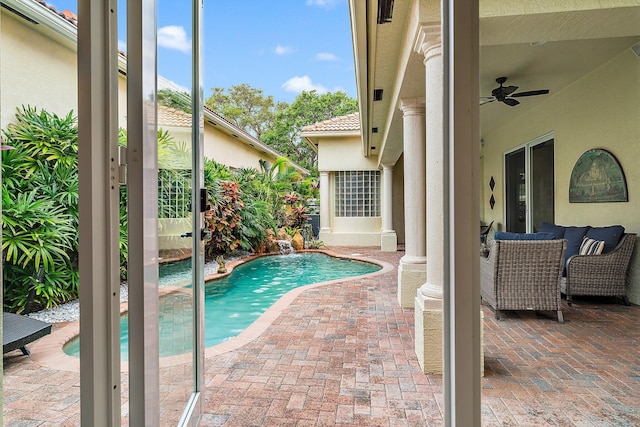 view of swimming pool with ceiling fan and a patio area