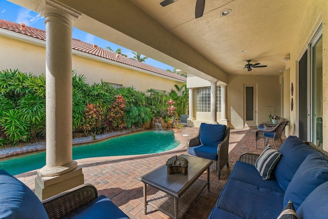 view of patio with an outdoor living space, ceiling fan, and pool water feature