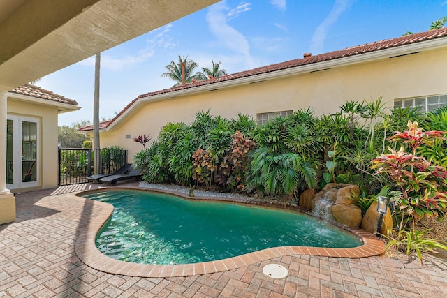 view of pool with a patio area and pool water feature