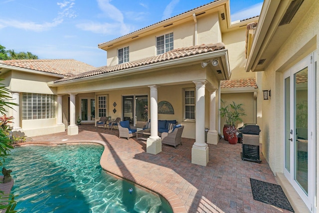 rear view of house featuring outdoor lounge area and a patio area