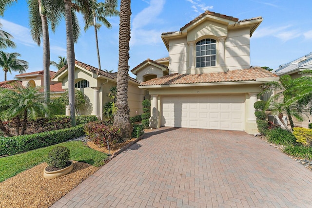 mediterranean / spanish house with a garage