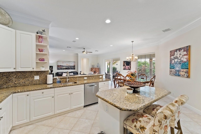 kitchen with hanging light fixtures, a kitchen island, stainless steel dishwasher, white cabinetry, and ceiling fan with notable chandelier