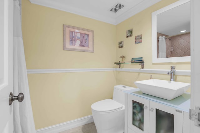 bathroom featuring vanity, toilet, and ornamental molding