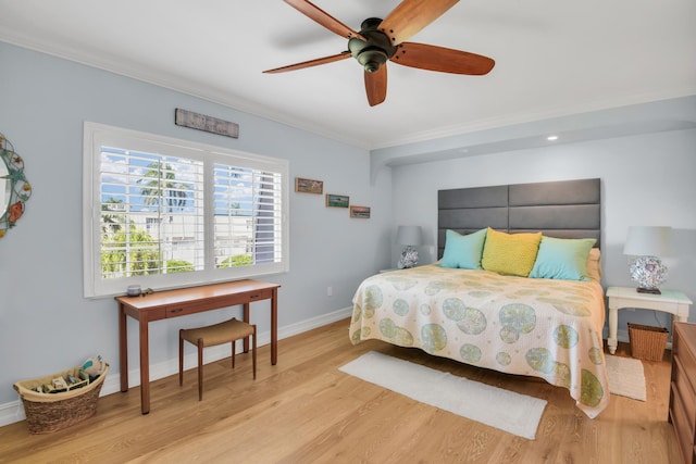 bedroom with ceiling fan, light hardwood / wood-style flooring, and crown molding