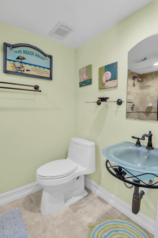 bathroom featuring tile patterned flooring, toilet, and sink