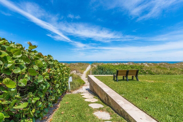 view of community featuring a lawn and a water view