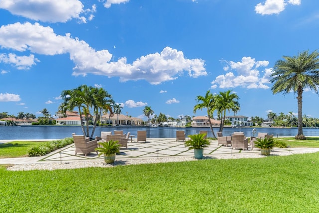 view of pool featuring outdoor lounge area, a yard, and a water view