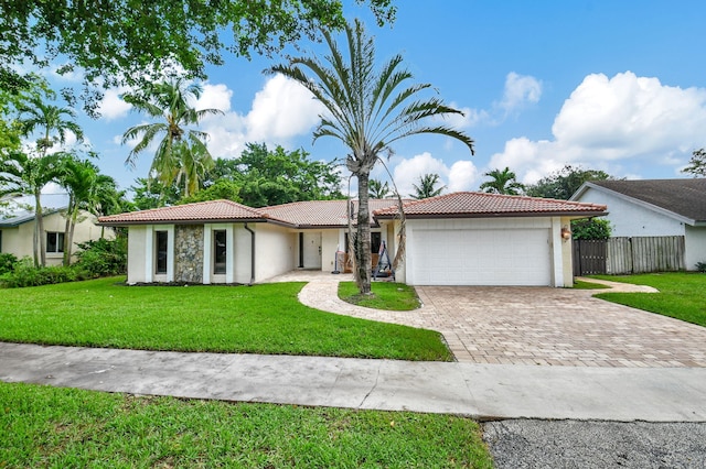 ranch-style home featuring a garage and a front yard