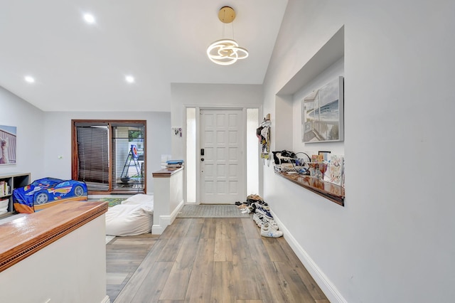 entryway featuring vaulted ceiling and light wood-type flooring