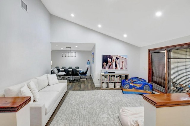 living room with high vaulted ceiling and wood-type flooring