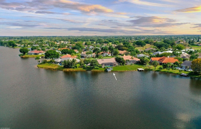 aerial view at dusk with a water view