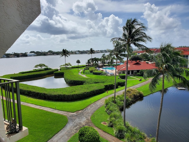 surrounding community featuring a water view, a yard, and a pool