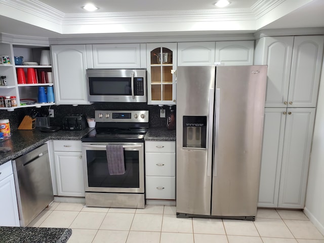 kitchen featuring ornamental molding, stainless steel appliances, white cabinets, and light tile patterned flooring